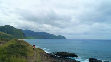 couple walking on the hill near the sea coast 4k