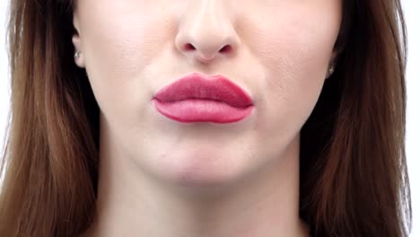 female is blowing a big bubble with her gum female is blowing a big bubble with her gum red lips brunette teeth closeup