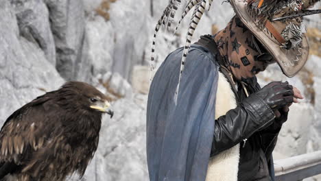 Slow-Motion-Falcon-and-Master-at-Jade-Dragon-Snow-Mountain,-Yunnan,-China