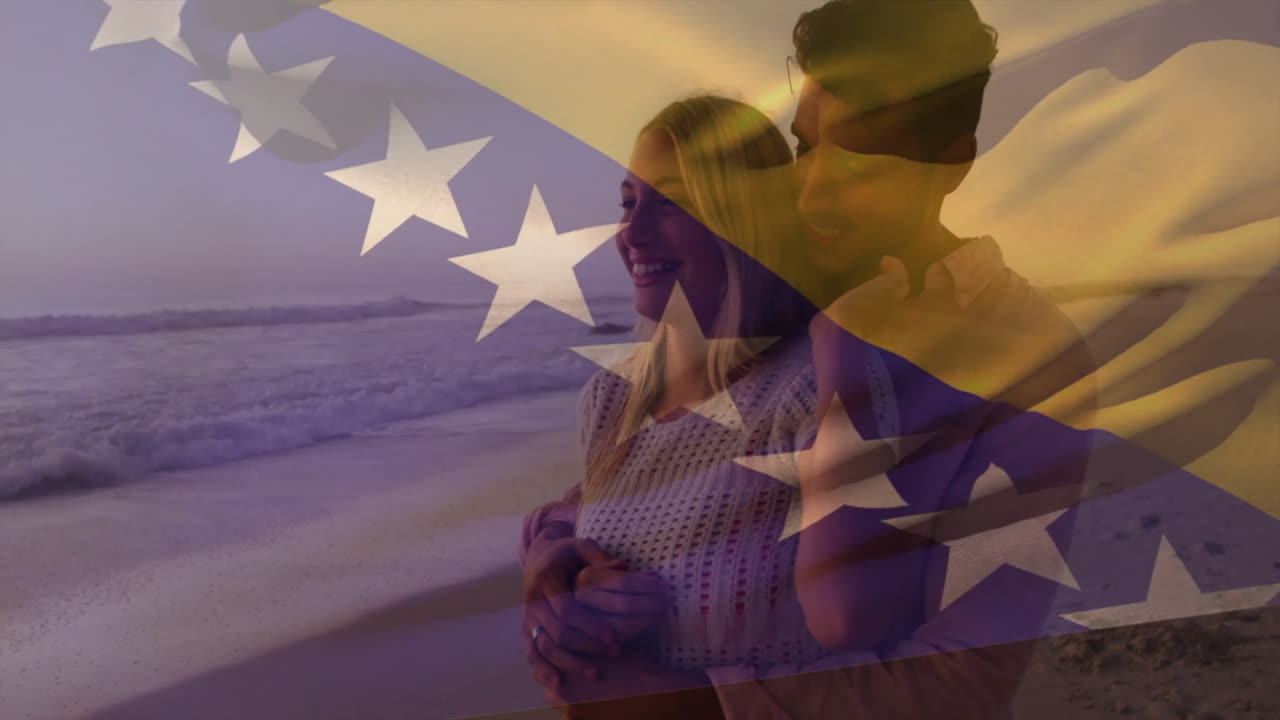 Embracing couple with starry flag animation overlay during warm sunset on beach