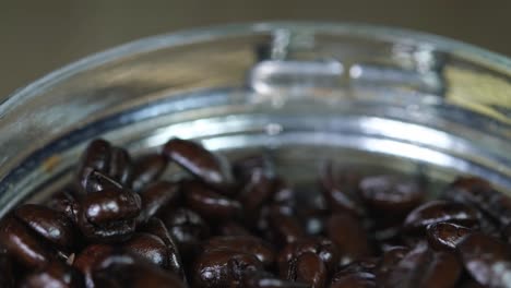 coffee beans in a container moving around revealing the roast