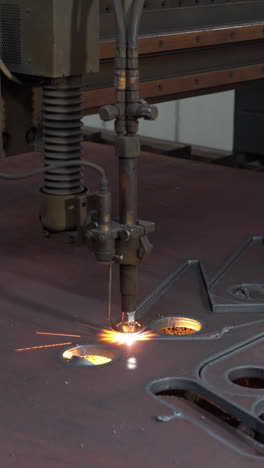 laser cutter in the production. industrial cnc plasma cutting of metal plate. production industry. vertical video