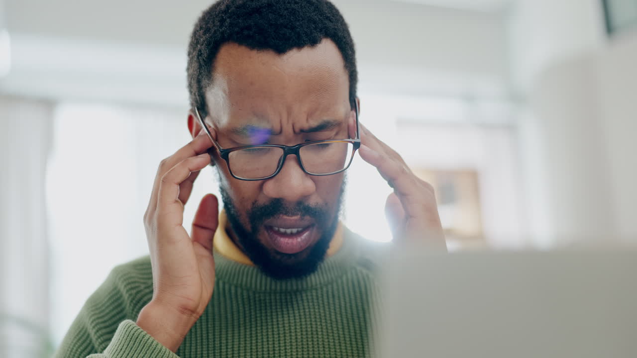 Man, remote work and headache at laptop
