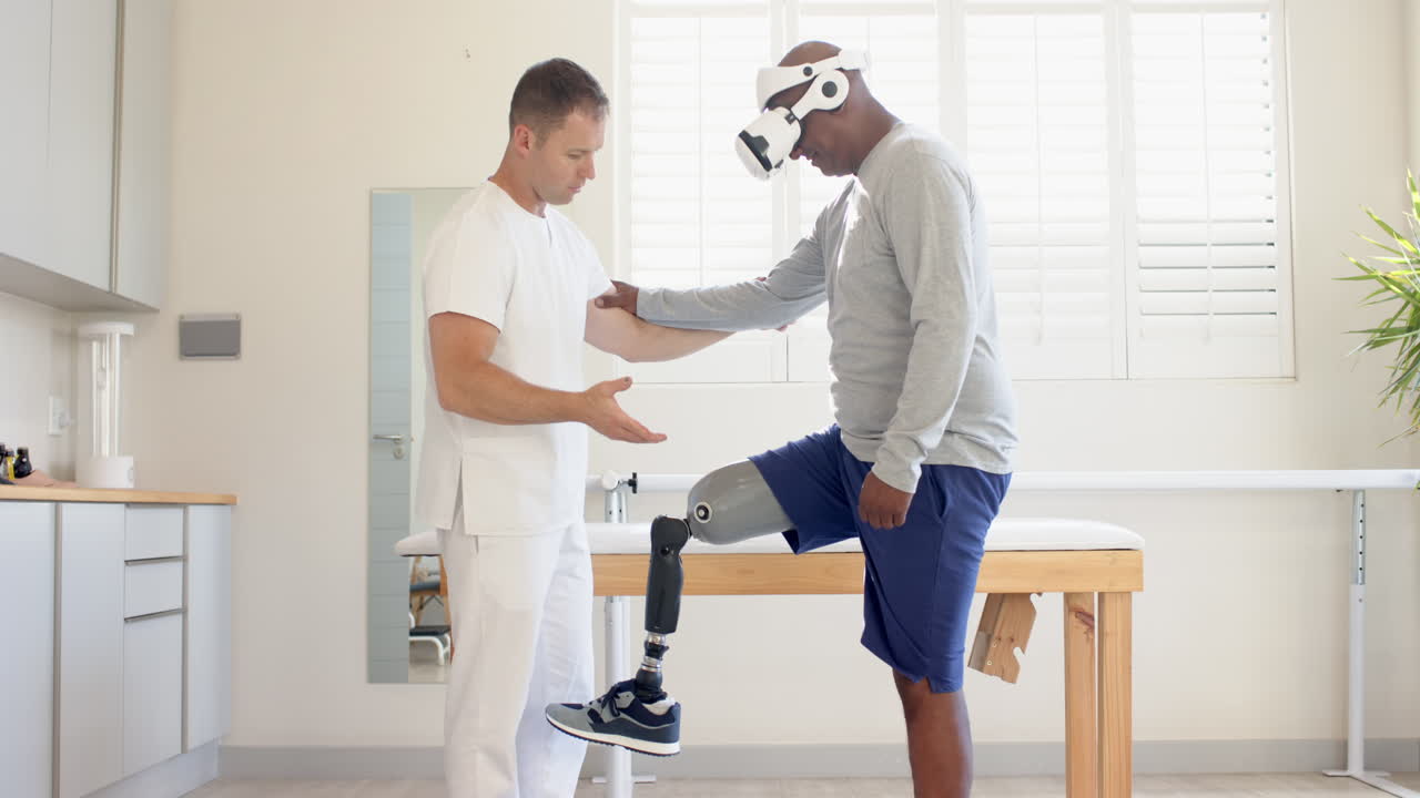 Man with prosthetic leg using VR headset with therapist in rehabilitation session