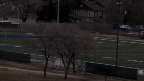 slow pan across small football field in morning