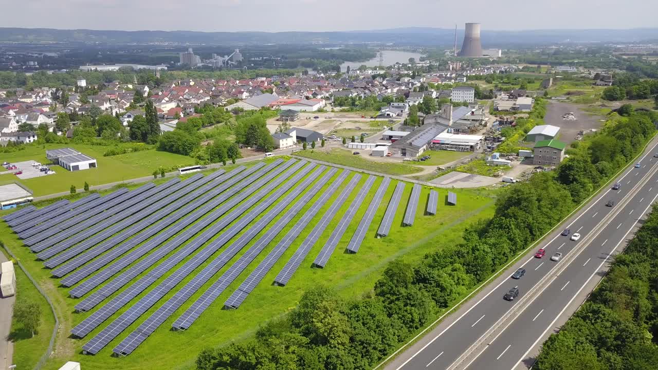 A wide-angle drone view of Weißenthurm’s solar farm, displaying its vast energy infrastructure and surrounding urban landscape.
