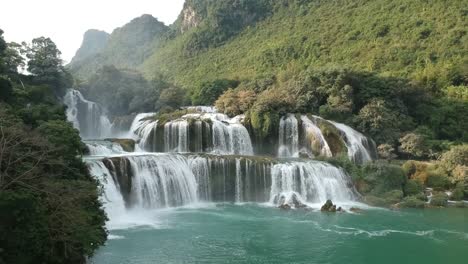 aerial view of cascading waterfalls of ban gioc with rainbow in vietnam. pedestal up