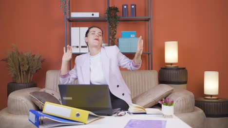 Home-office-worker-young-woman-dances-looking-at-camera.