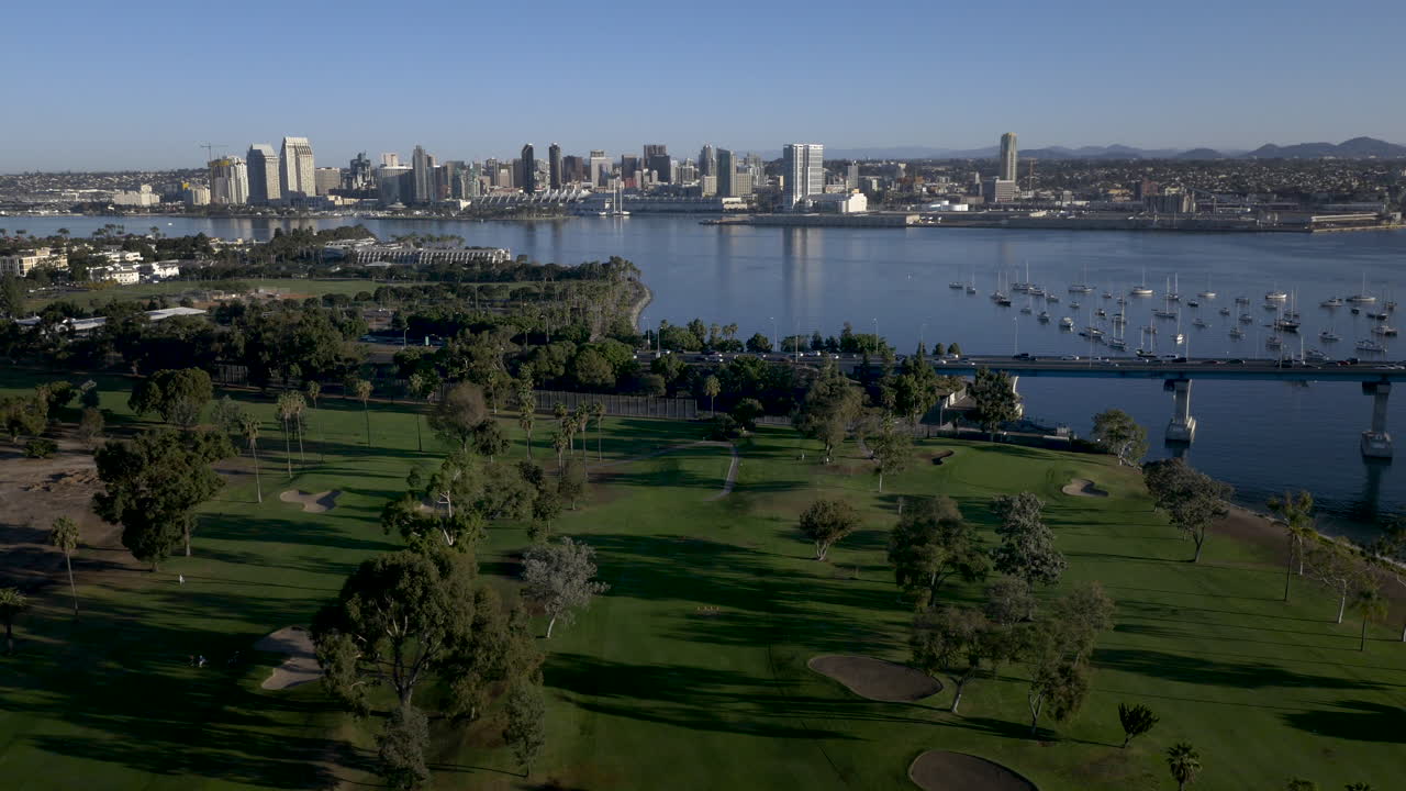 Aerial view of San Diego skyline and bay with a golf course in the foreground