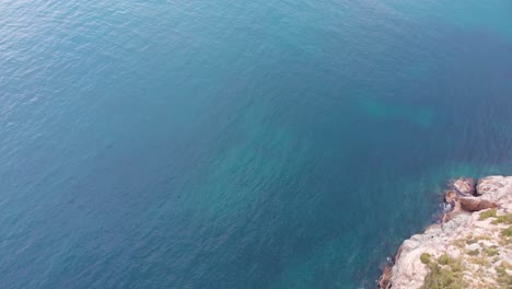aerial, tilt up, drone shot revealing the puerto de soller marina and village, partly sunny day, in mallorca, spain
