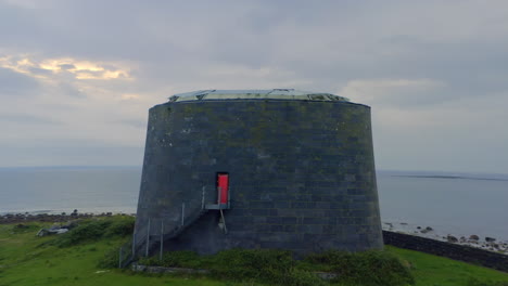 close up aerial orbit of aughinish martello tower at twilight, county clare ireland