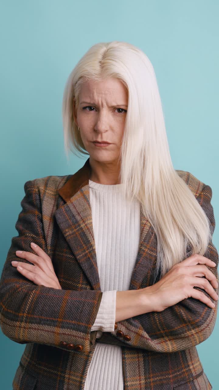 Blonde Woman with Crossed Arms Expressing Disapproval