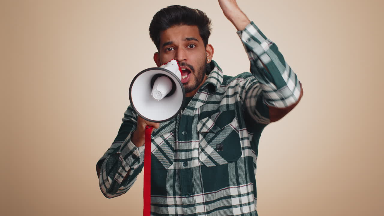 Man talking with megaphone proclaiming news loudly announcing advertisement pointing empty place