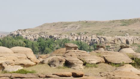 wide angle establishing shot of hoodoo rock formations in hot valley