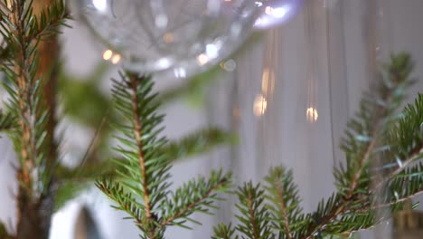 christmas baubles hanging in real authentic christmas tree, close up tilting down