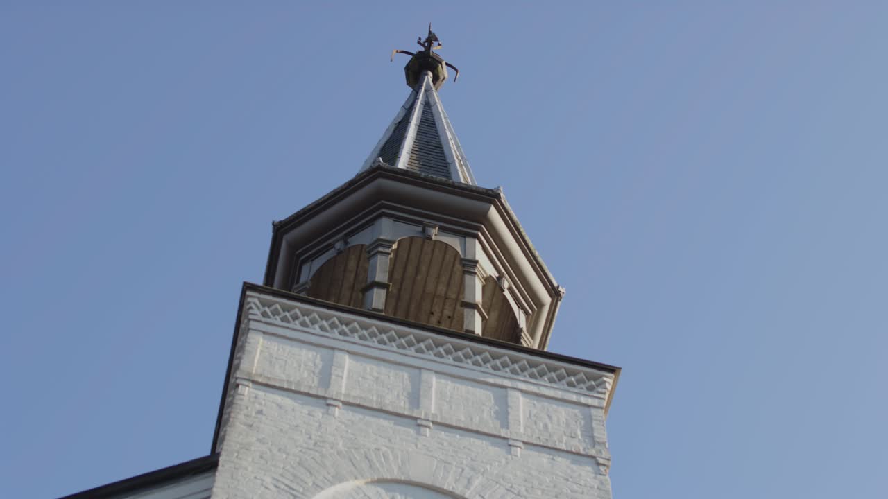 Close low angle pan of a beautiful and historical church tower on a sunny day