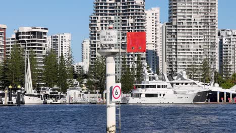 a boat navigates through a busy harbour