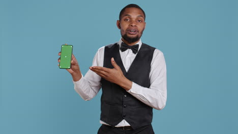 hotel worker bellhop points at phone with isolated mockup display