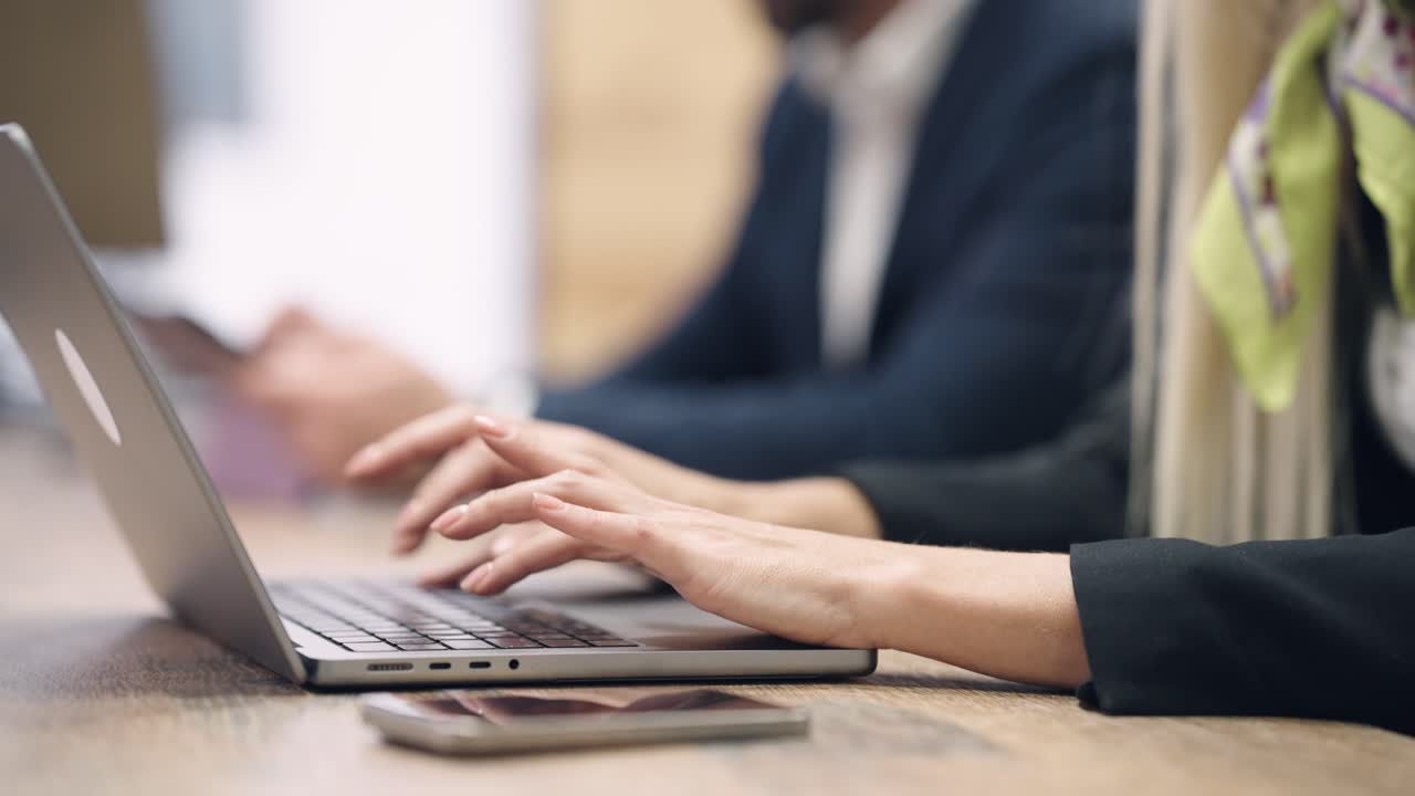 Close-up of Woman's Hands Typing on Laptop Keyboard in Office