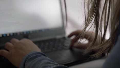 Busy-woman-working-on-a-laptop-in-office-close-up-shot