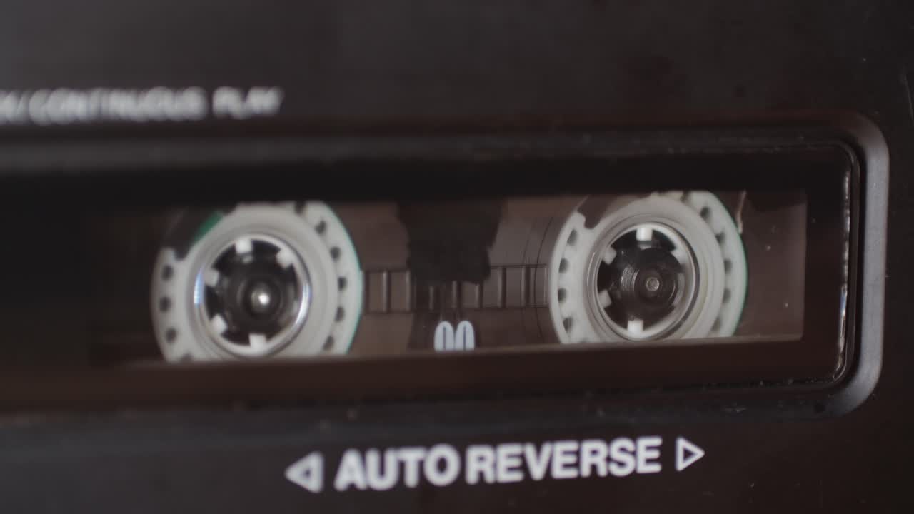 Retro radio tape recorder, audio cassette close-up. Listening to music, old radio boom box player, macro of vintage music listening.
