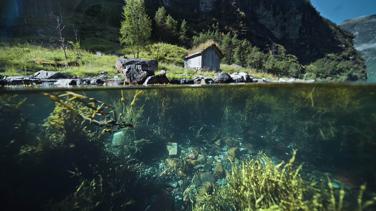 Stunning Underwater View of a Secluded Cabin by a Fjord