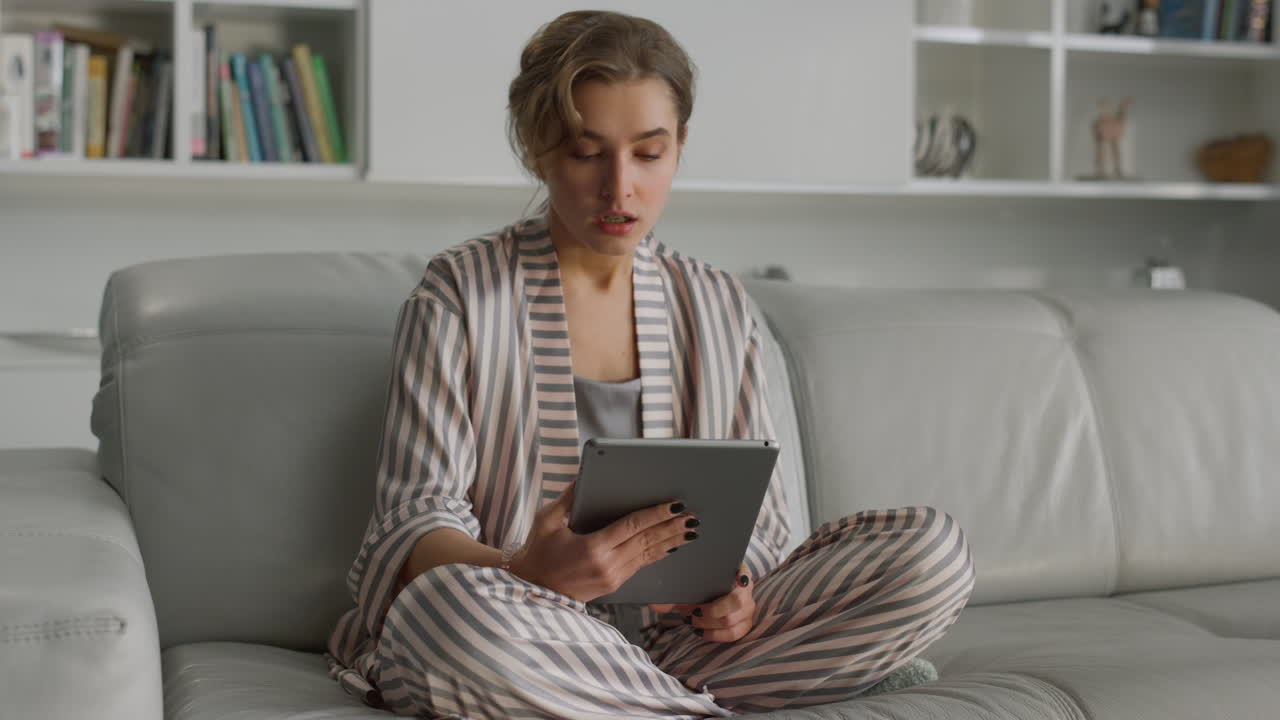 Ill businesswoman working home online. Tired lady having video call on tablet.