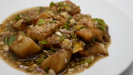 Close-Up-Footage-of-Deep-Fried-Seabass-Stir-Fried-With-Chilli-and-Garlic-Sauce,-Hot-and-Spicy-Thai-Dish