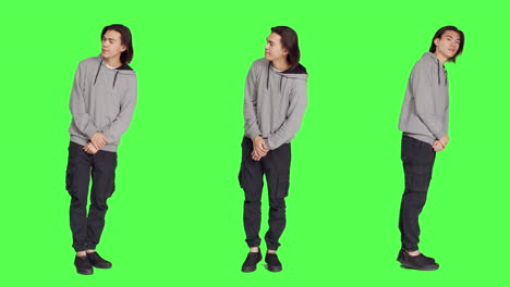 Young-guy-poses-against-greenscreen