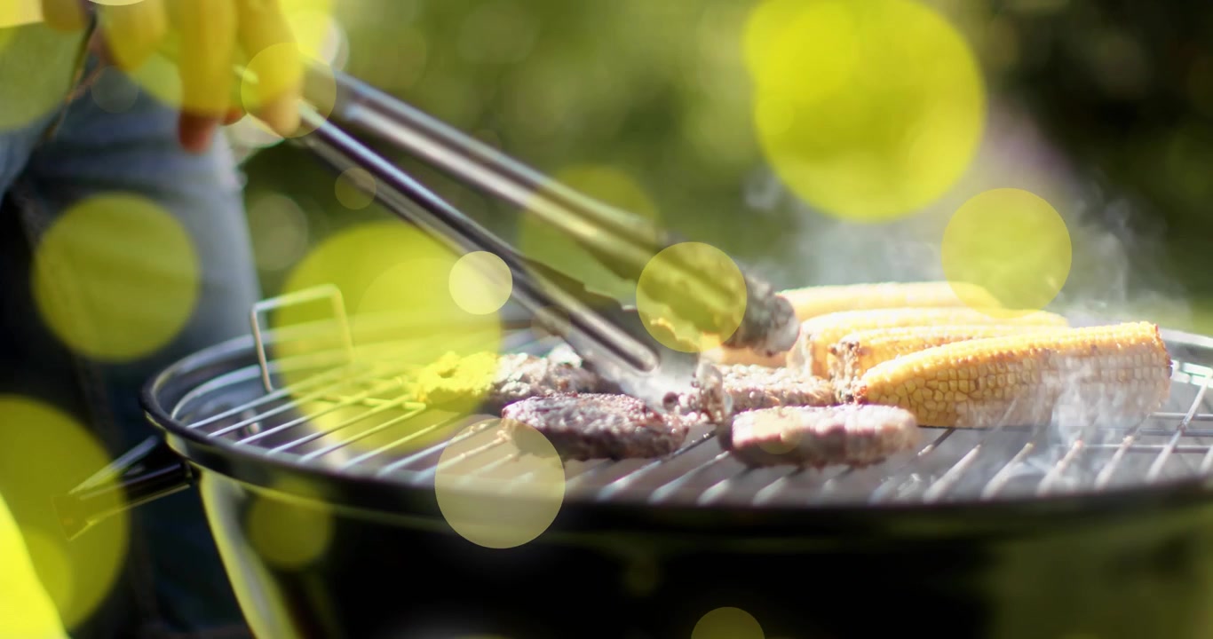 Stepping into frame gripping tongs, chef flipping patties rotating corn for even cooking bbq grill