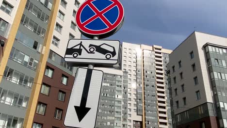Road sign parking prohibited evacuation on the background of modern apartments buildings. Modern residential quarter. No Parking!