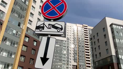 road sign parking prohibited evacuation on the background of modern apartments buildings. modern residential quarter. no parking!