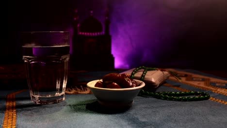 water and dates. iftar is the evening meal. slider view of decoration ramadan kareem holiday. festive greeting card, invitation for muslim holy month ramadan kareem. dark background. selective focus