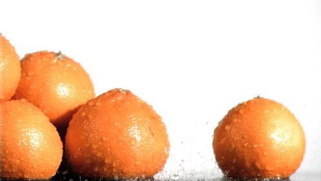 water falling in super slow motion on oranges