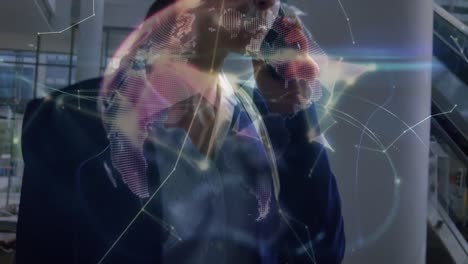 Animation-of-connections-and-globe-over-happy-caucasian-businesswoman-using-smartphone