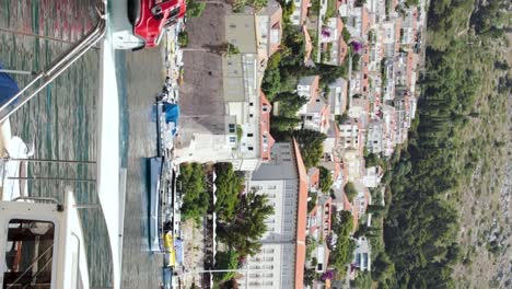 boat arriving into the old town port. many motorboats and yachts are moored in the old port in dubrovnik, croatia
