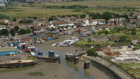 pullback aerial establishing shot from the lock at queenborough on the isle of sheppey, kent, uk to reveal sheerness town - port