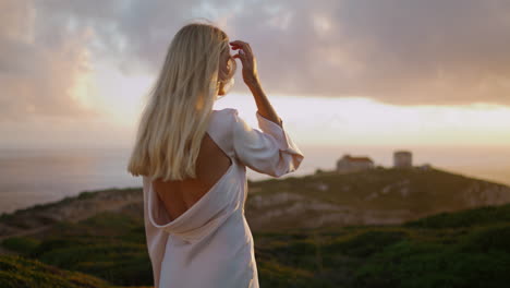 dress girl staring camera at evening shore vertically. positive woman attracting