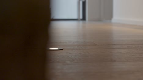 slow motion revealing shot of led foot lighting along a wall within a villa