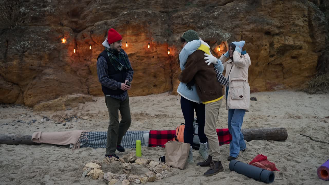 Friends Camping on the Beach at Night