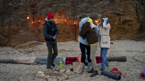 friends camping on the beach at night