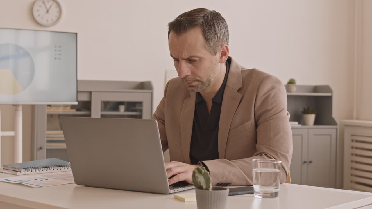 Caucasian Manager Talking on Phone in Office