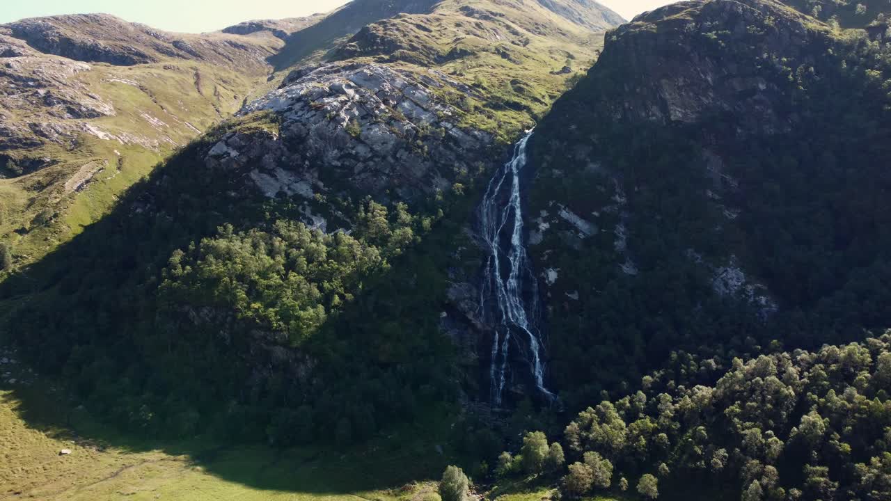 Aerial panoramic natural drone environment Steall Waterfall, Ben Nevis, Scotland stream falling at green countryside valley fields