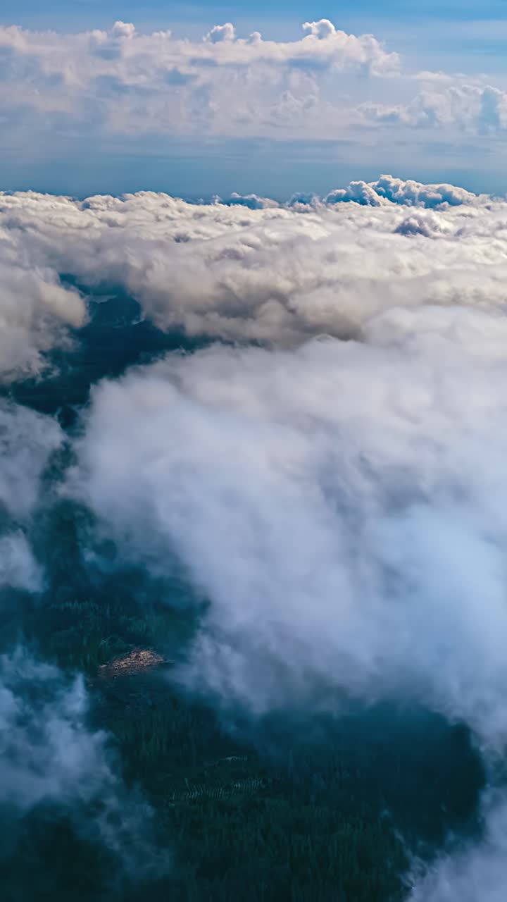Aerial hyperlapse above thick cumulus and stratus cloud layers, vertical