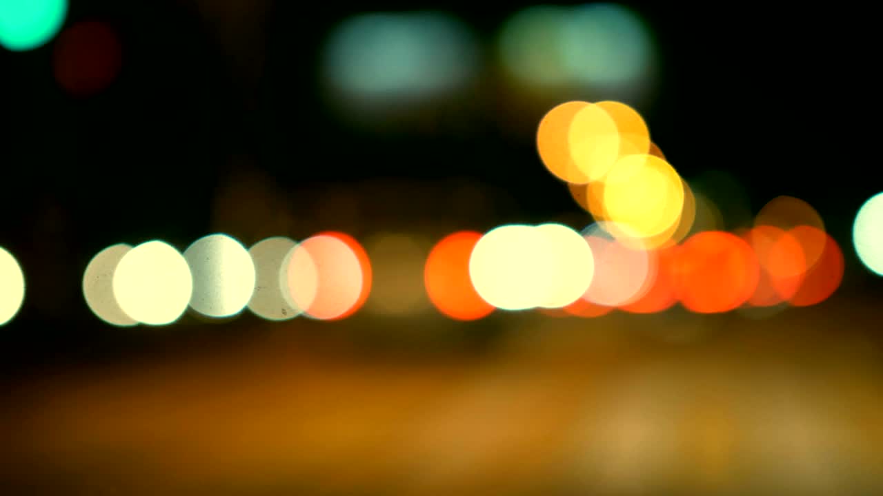 conducir un coche a través de la carretera de la noche, la autopista. luces desenfocadas calle de los ángeles resumen. ciudad fondo borroso. movimientos círculos bokeh de tráfico nocturno.