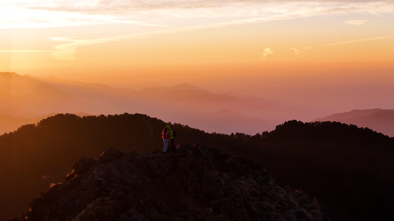 Aerial drone shot showcasing the first light of dawn touching the peaks around Nainital’s mountain landscape.