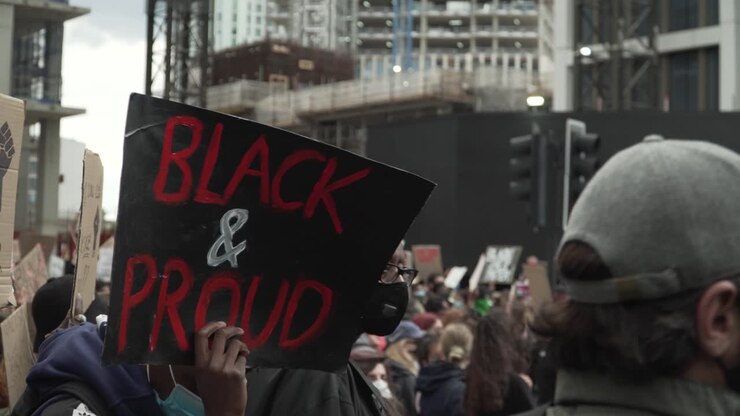 Young Protestor Holds Up a Sign During London BLM Protests
