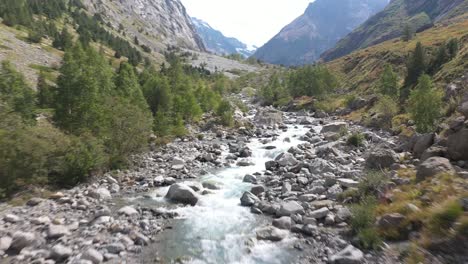 Stunning-aerial-flyover-shot-of-powerful-river-rapids-running-through-a-mountain-landscape