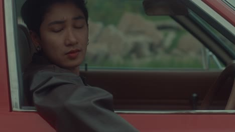 person in a red car