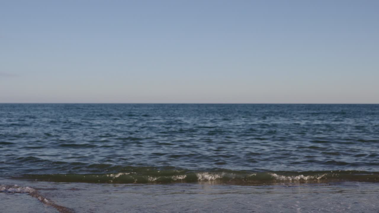Beach scene with woman in swimsuit and inflatable